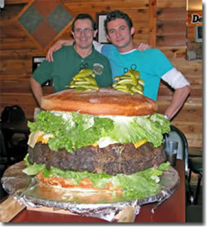 Denny Liegey poses with 100 pound burger