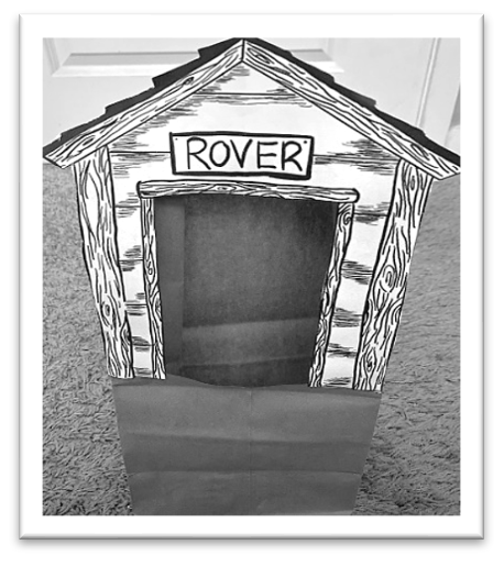 Rover doghouse handout with doorway cutout and glued onto paper bag with matching cutout at top of bag  