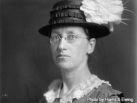 Photo of Emily Balch wearing hat and wire-rimmed glasses