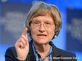 Drew Gilpin Faust wearing glasses and a suit addressing an audience.