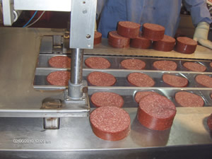 Lebanon bologna being sliced at the factory