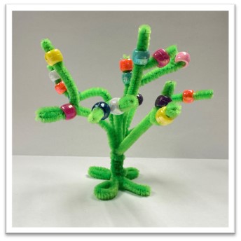 four green pipe cleaners bent together to create a small tree, decorated with colorful pony beads 